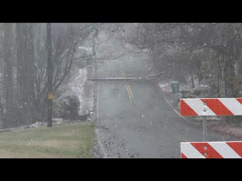 Snow falling in Sandy Springs, road closed due to downed utility pole