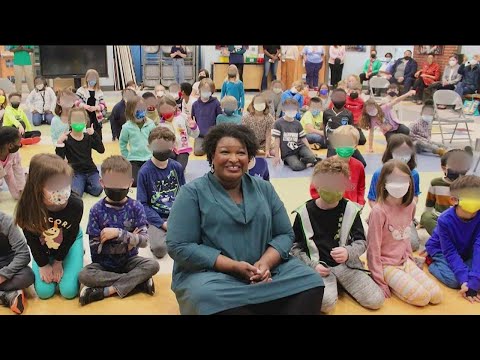 Stacey Abrams apologizes after taking a picture without a mask during school event
