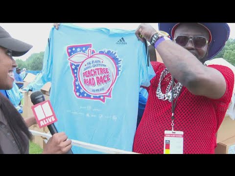 Volunteers unveil 2022 AJC Peachtree Road Race T-shirt