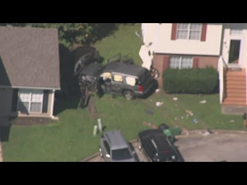 SUV riddled with bullets crashes into house after driver struck, police say