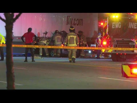 Woman killed when SUV crashes, gets pinned under tractor-trailer in Atlanta, officials say