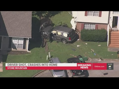 SUV riddled with bullets crashes into DeKalb County home, driver wounded