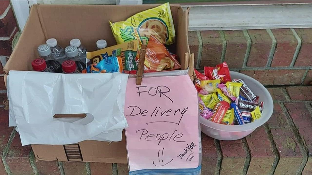 Woman offering Halloween treats to delivery drivers