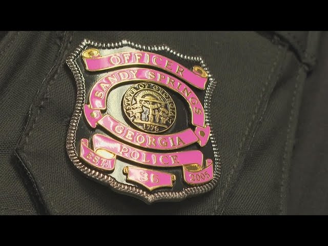 Sandy Springs Police officers wear pink badges for breast cancer awareness